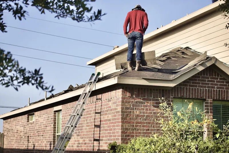 Professional roofer working on a residential roof in Marion Franklin